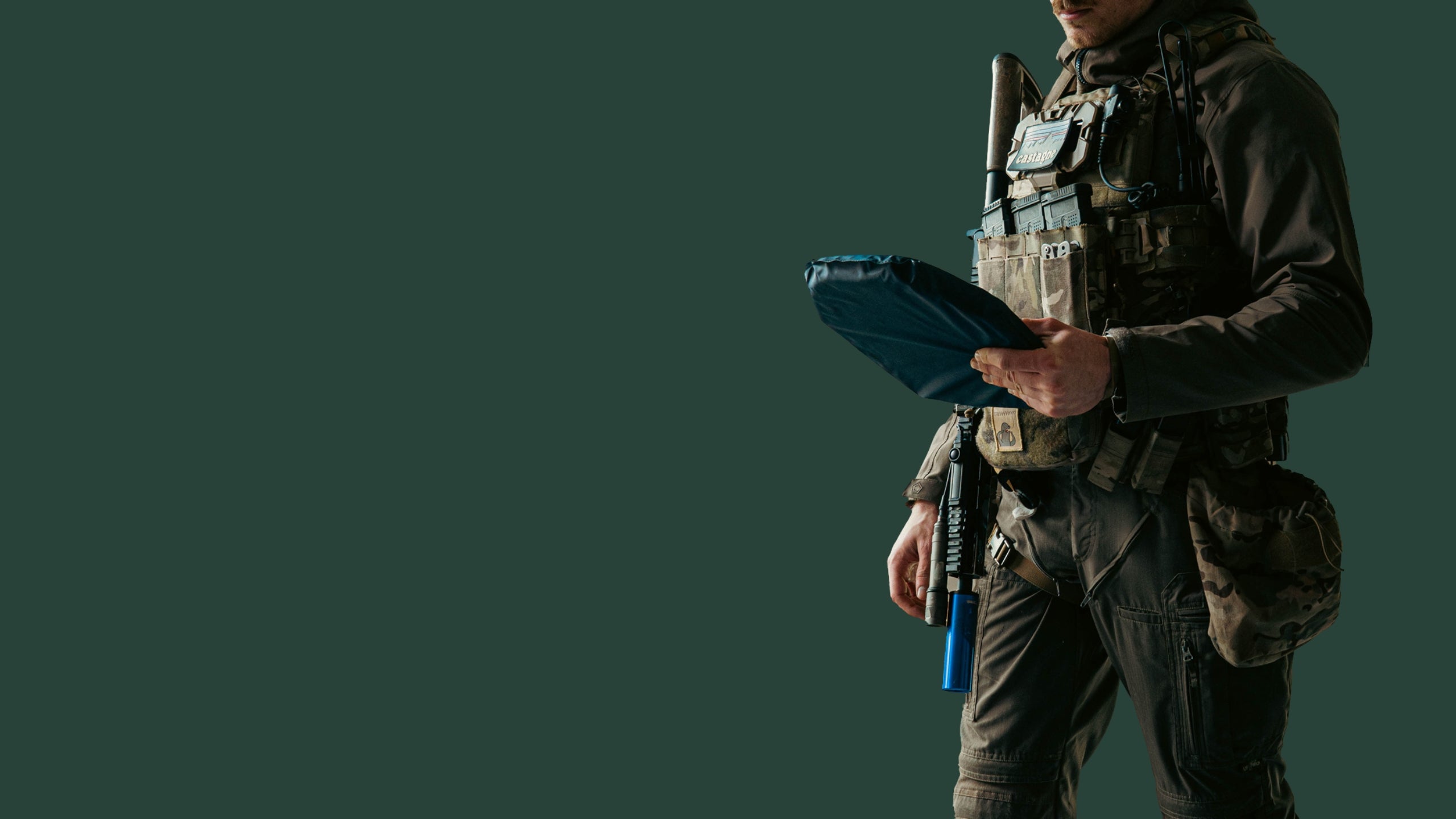 Tactical operator holding Pangolin flexible ballistic plate, NIJ rated body armor
