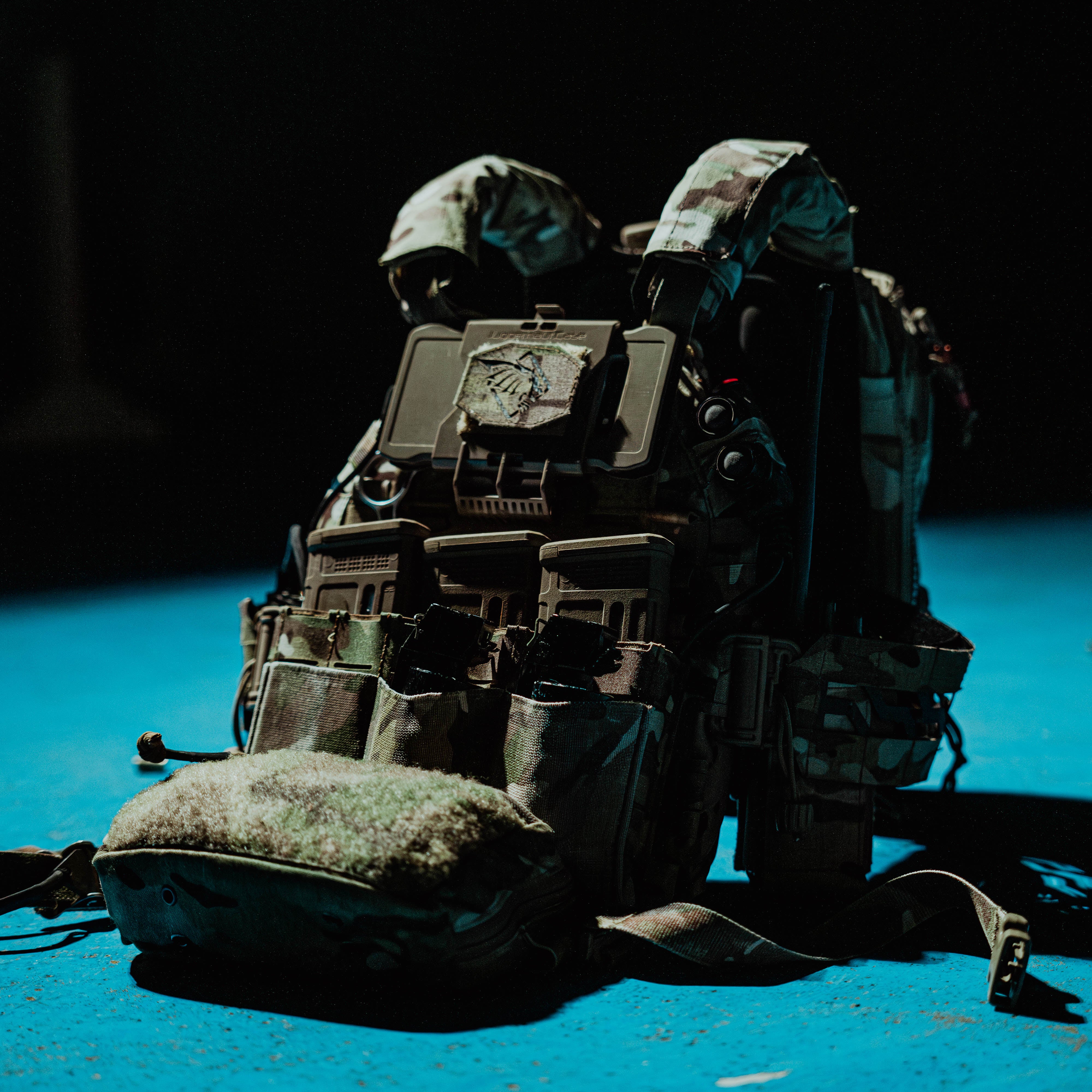 PGL Armor tactical plate carrier with pouches and gear under low light